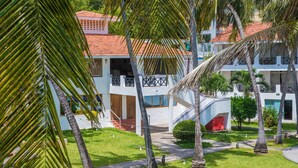 A resort with multiple buildings, palm trees, and a well-maintained lawn. - Nyali Beach Holiday Resort (Mombasa)