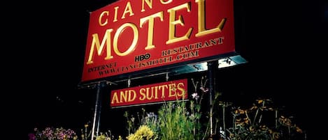 A motel sign with the name "CIANCI'S MOTEL" and mentions "HBO" and "www.ciancismotel.com".