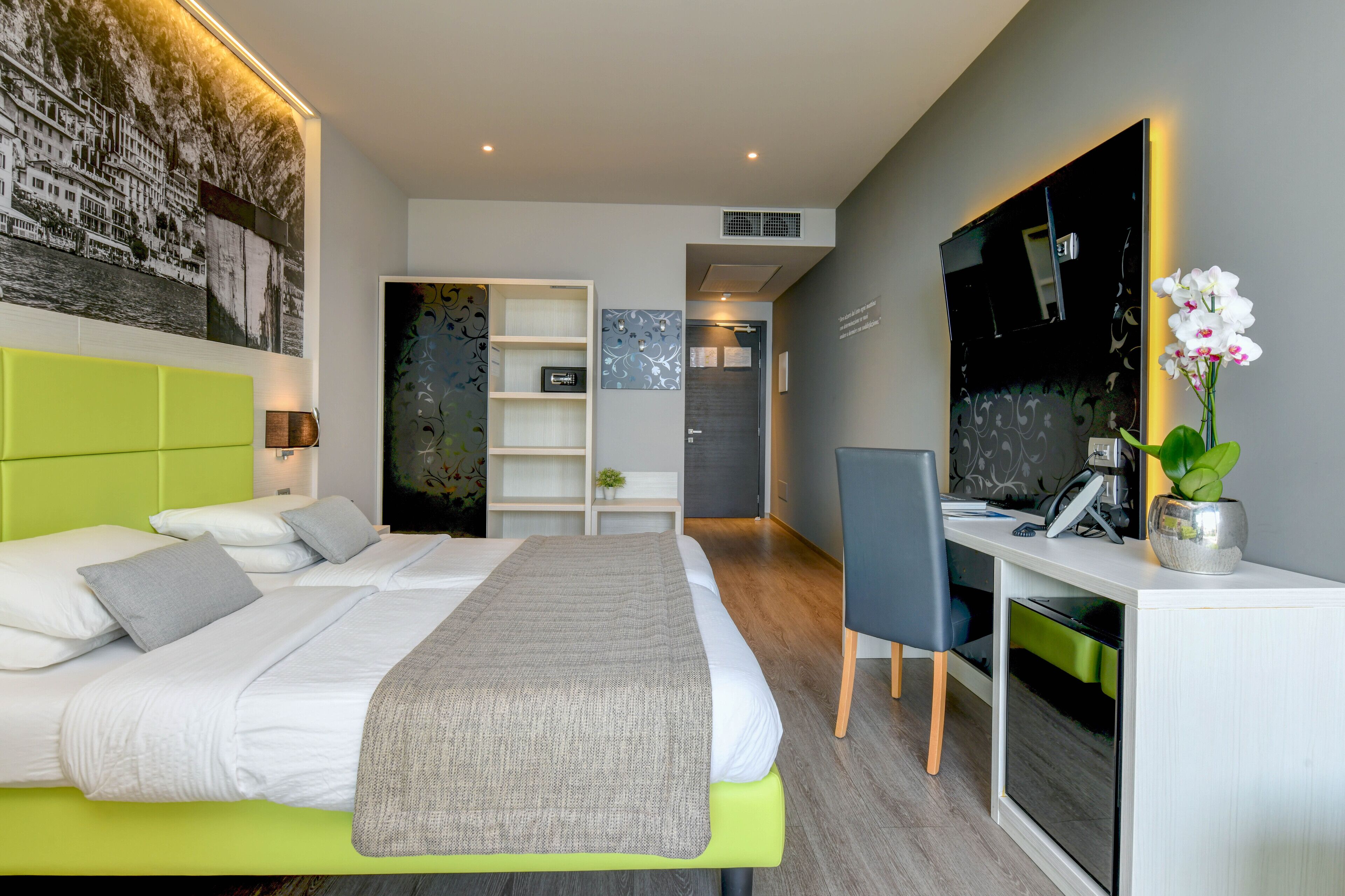 Une chambre d’hôtel moderne équipée d’un lit, d’un bureau et d’un coin salon.
