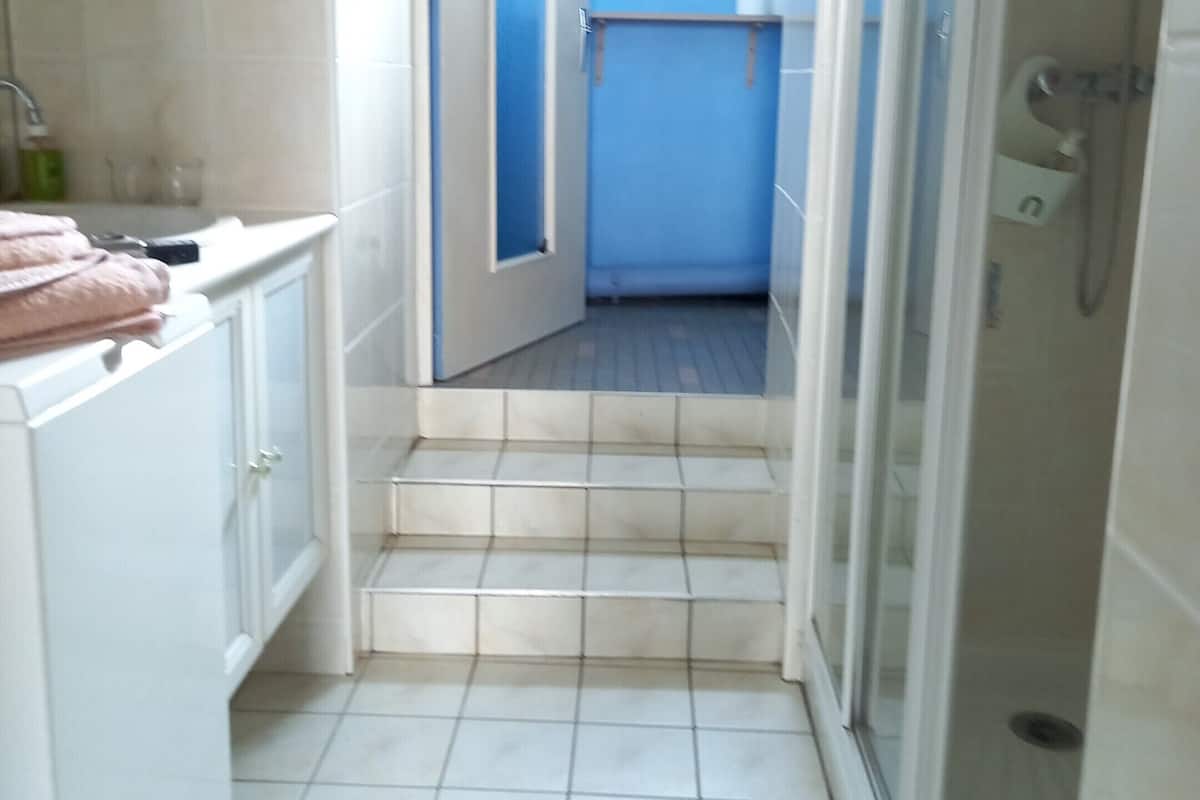 A bathroom with a shower, a sink, and a toilet.