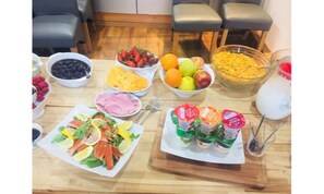 Uma mesa com diversos alimentos, incluindo frutas, legumes e temperos.
