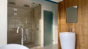 A modern bathroom with a glass-enclosed shower, a white sink, and a wooden panel wall.