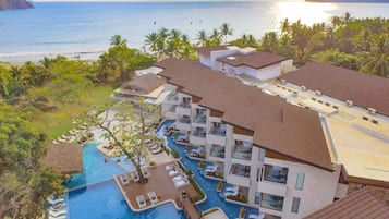 Relax by the pool surrounded by palm trees and ocean views.