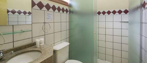A bathroom with a sink, toilet, and shower.