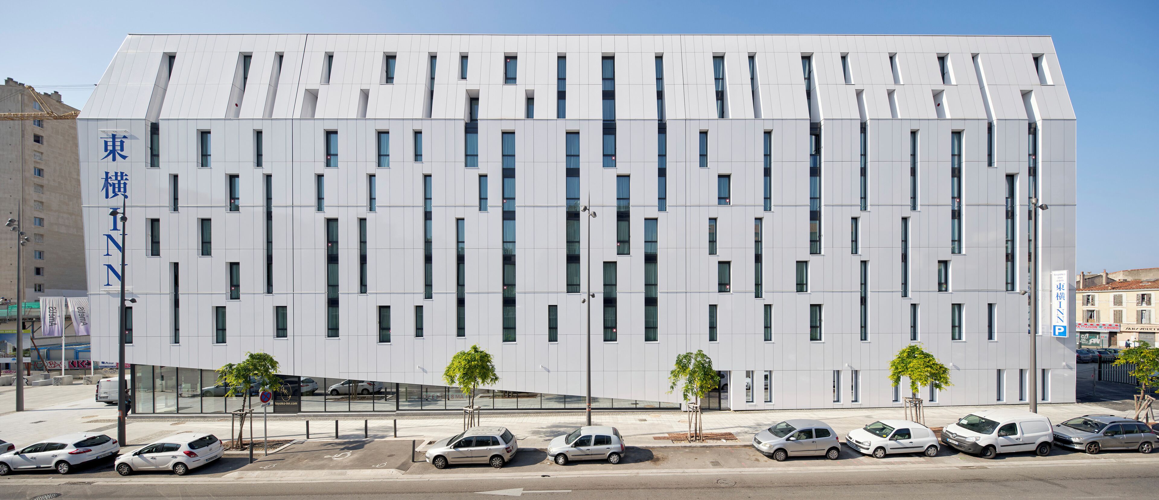 A modern building with a grid of windows and a flat roof.