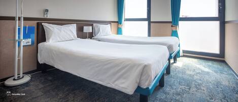 A hotel room with two beds, a clock, a lamp, and a view of the outside.