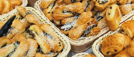 Baskets filled with various pastries, including croissants and rolls, likely available for purchase.