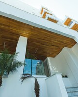 Un edificio moderno con techo de madera y fachada de vidrio.
