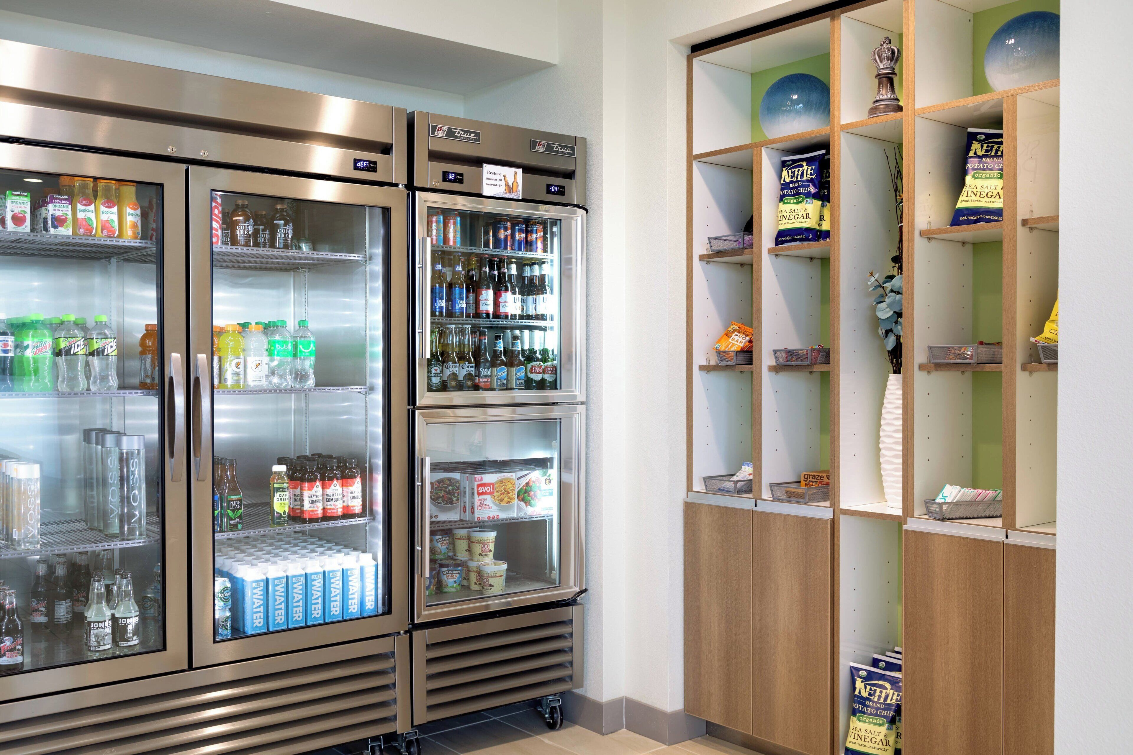 A refrigerated display with various beverages and snacks.