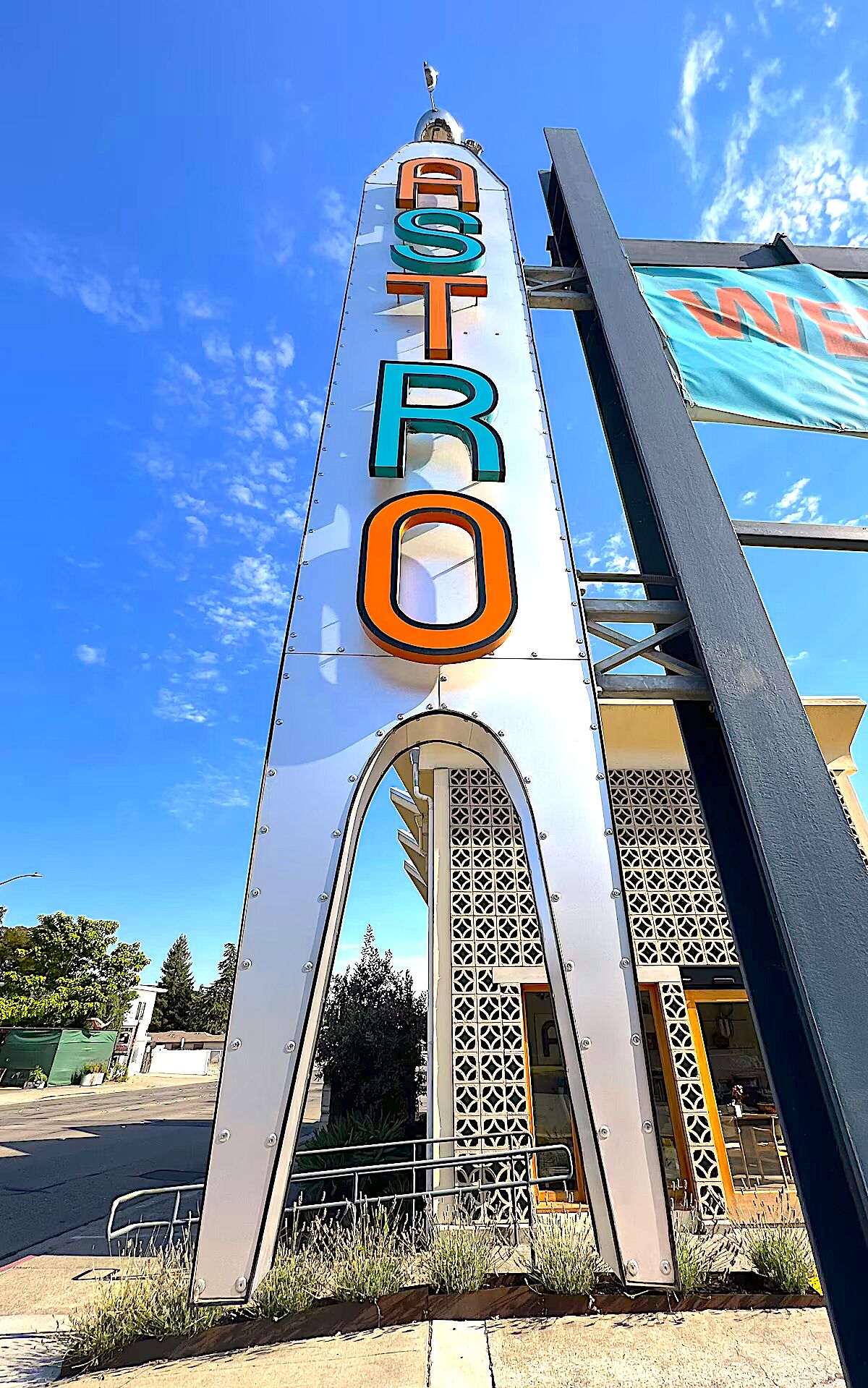 A tall, metallic sign with the word "ASTRO" in large, colorful letters.