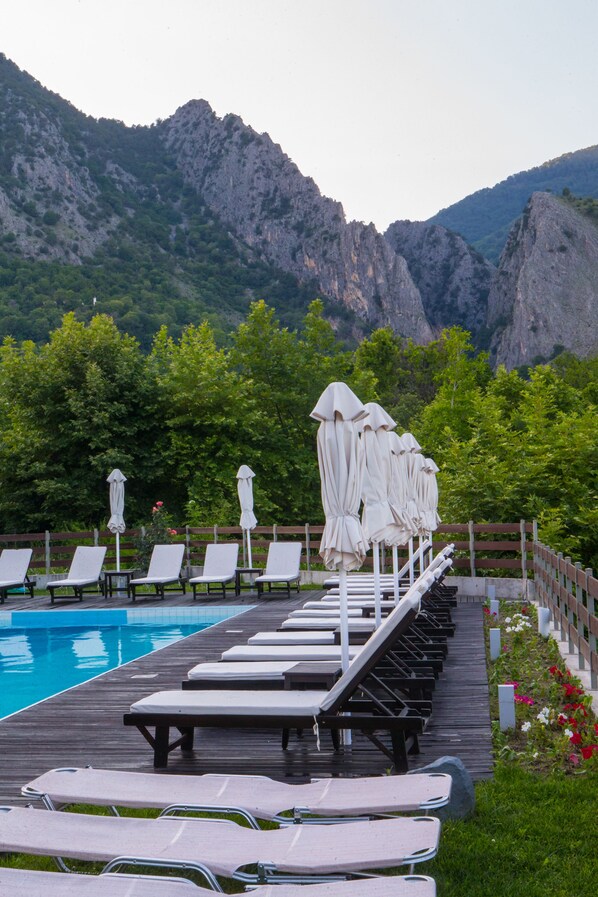 Indoor pool, outdoor pool, pool umbrellas, pool loungers