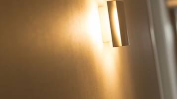 A wall-mounted light fixture with a rectangular shape and a narrow, elongated design.