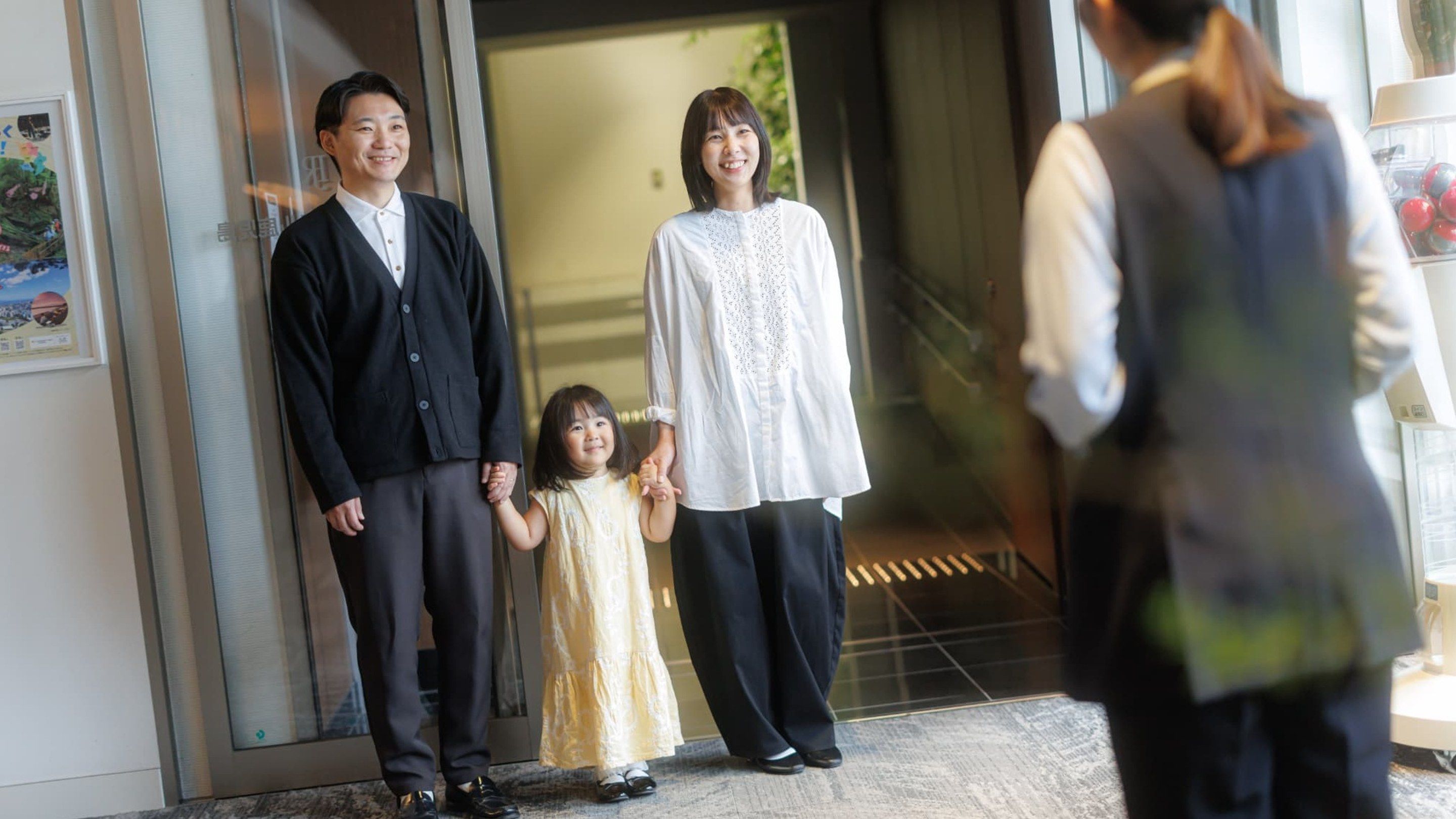 A group of people standing at the entrance of a building.