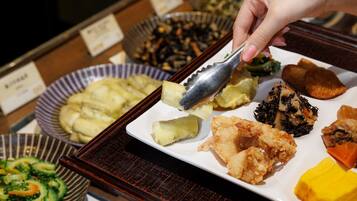 A buffet with various dishes including fried items, vegetables, and a variety of side dishes.