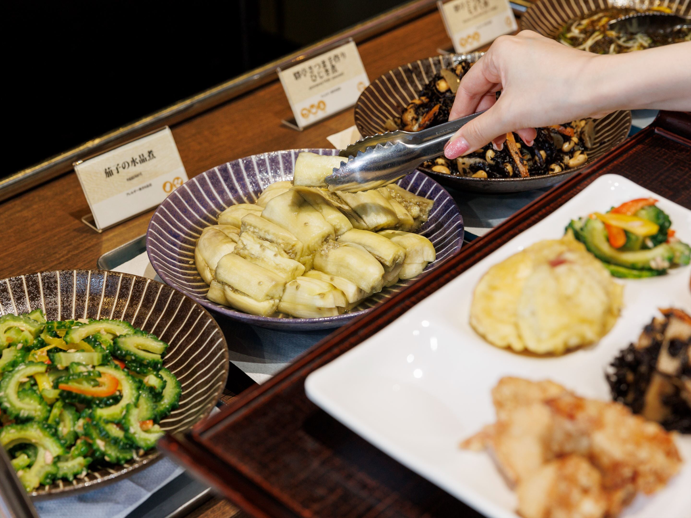 A buffet with various dishes including dumplings, vegetables, and seafood.