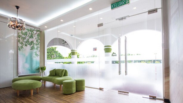 A modern lobby with a wooden floor, green upholstered seating, a large window with a view, and a sign reading "KELUAR". - S Hotel (Seberang Jaya)
