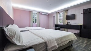 A hotel room with two beds, a TV, a desk, and a mirror. - S Hotel (Seberang Jaya)