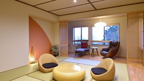 A traditional Japanese-style room with tatami flooring, a low table, and a seating area with woven chairs. - Ryokan Okayama (Myoko)