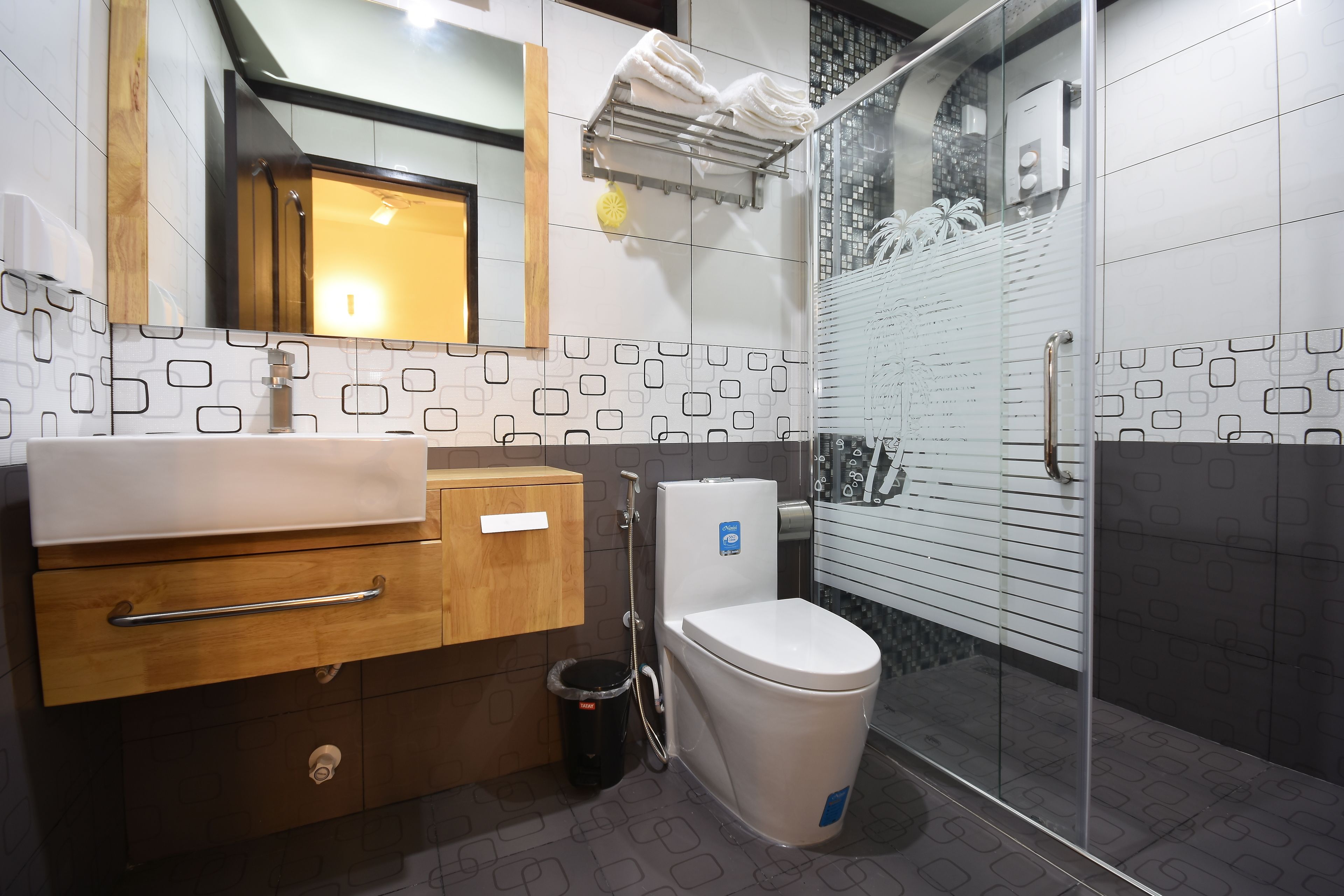 A modern bathroom with a sink, toilet, and shower area.
