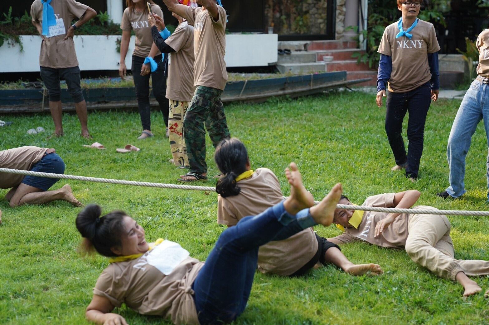 A group of people participating in an outdoor activity on a grassy field.