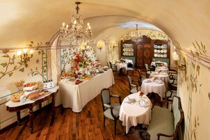 Un ristorante con pavimenti in legno, tovaglie bianche e decorazioni floreali.