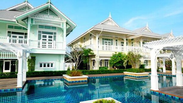 A resort with a large swimming pool, traditional architecture, and well-maintained gardens. - Moon Margo (Cha-am)