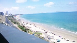 A coastal cityscape with a beach, buildings, and a clear sky. - Ocean Star Hotel (Ho Chi Minh City)