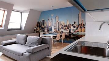 Suite estudio urbana | Área de sala de estar | Televisión de pantalla plana