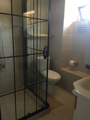 Junior Studio, Garden View | Bathroom | Shower, rainfall showerhead, hair dryer, slippers