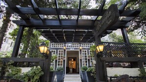 A wooden pergola entrance with a sign reading "Bonita Inn."