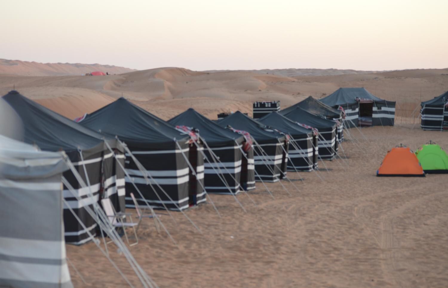 A row of tents in a desert setting.