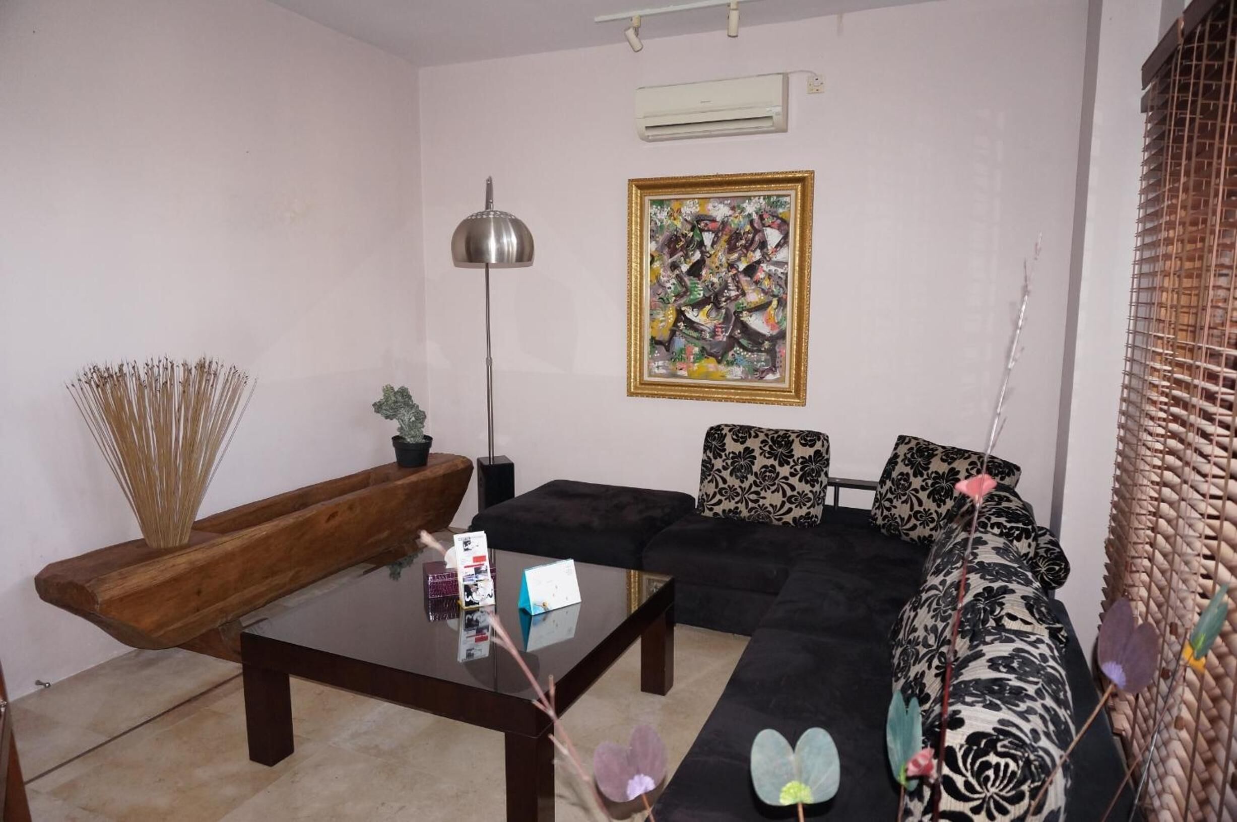 Ein Wohnzimmer mit einer Couch, einem Couchtisch und einer Lampe.