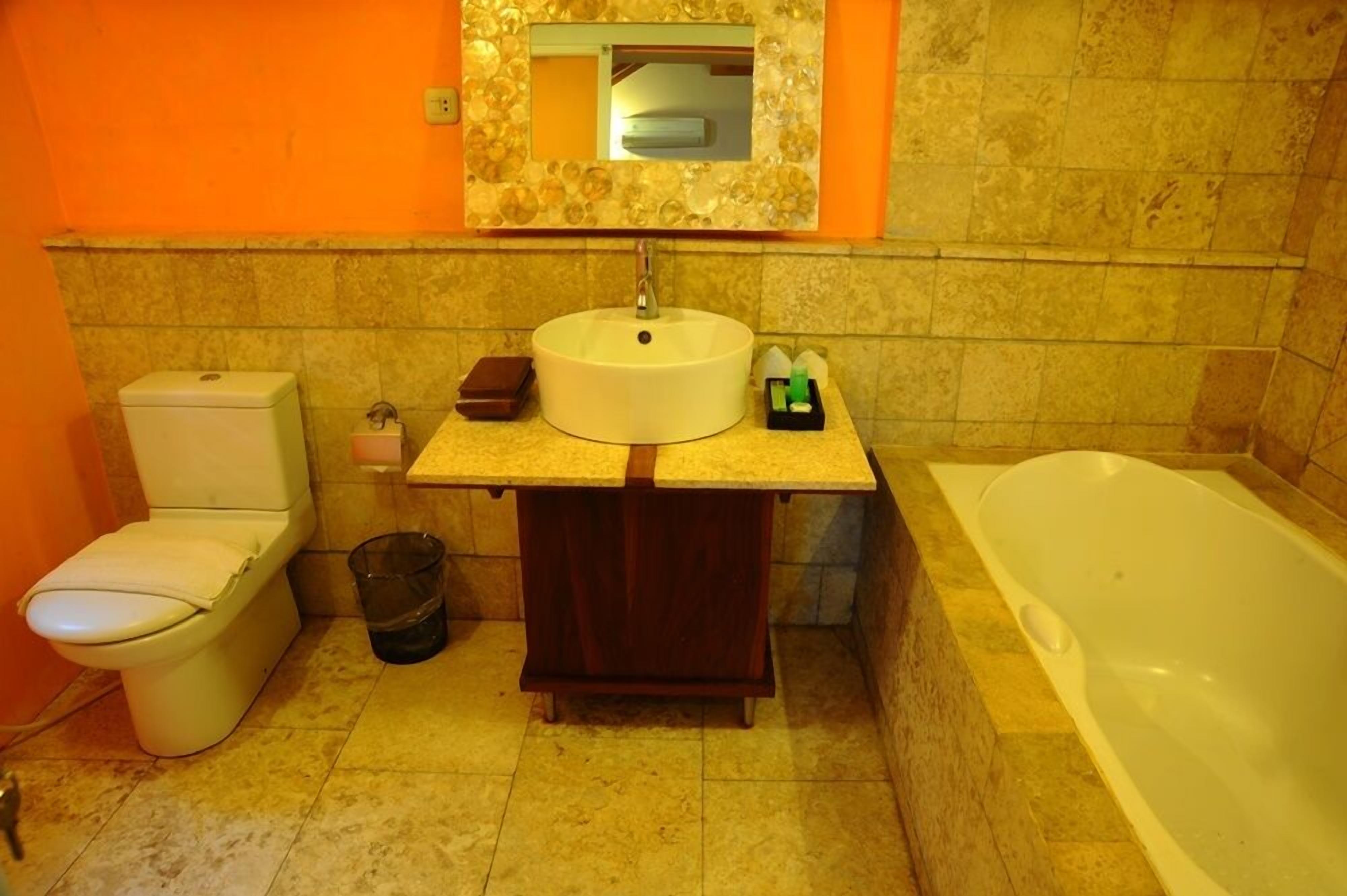 A bathroom with a toilet, sink, and bathtub.