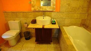 A bathroom with a toilet, sink, and bathtub.