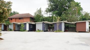 A row of single-story buildings with a flat roof, likely part of a residential or small hotel complex.
