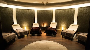 Relax in a serene, circular room with four reclining chairs and a tranquil ambiance.