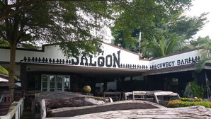 A building with a sign reading "PALON" and "COWBOY BAR". - Chortip Resort (Pak Phli)