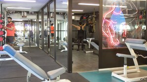 A gym with various exercise equipment, including dumbbells, benches, and a treadmill. - Hamra Urban Gardens (Beirut)