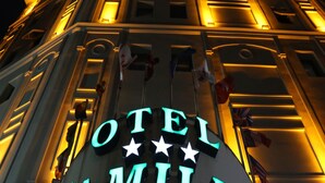A hotel sign with the name "HOTEL FAMILIA" illuminated in neon lights. - Otel Familia (Orhangazi)