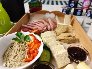 A tray with various food items including sliced meats, cheeses, vegetables, and dips. - Pension Buon Gusto Sibiu - motorcycle friendly (Sibiu)