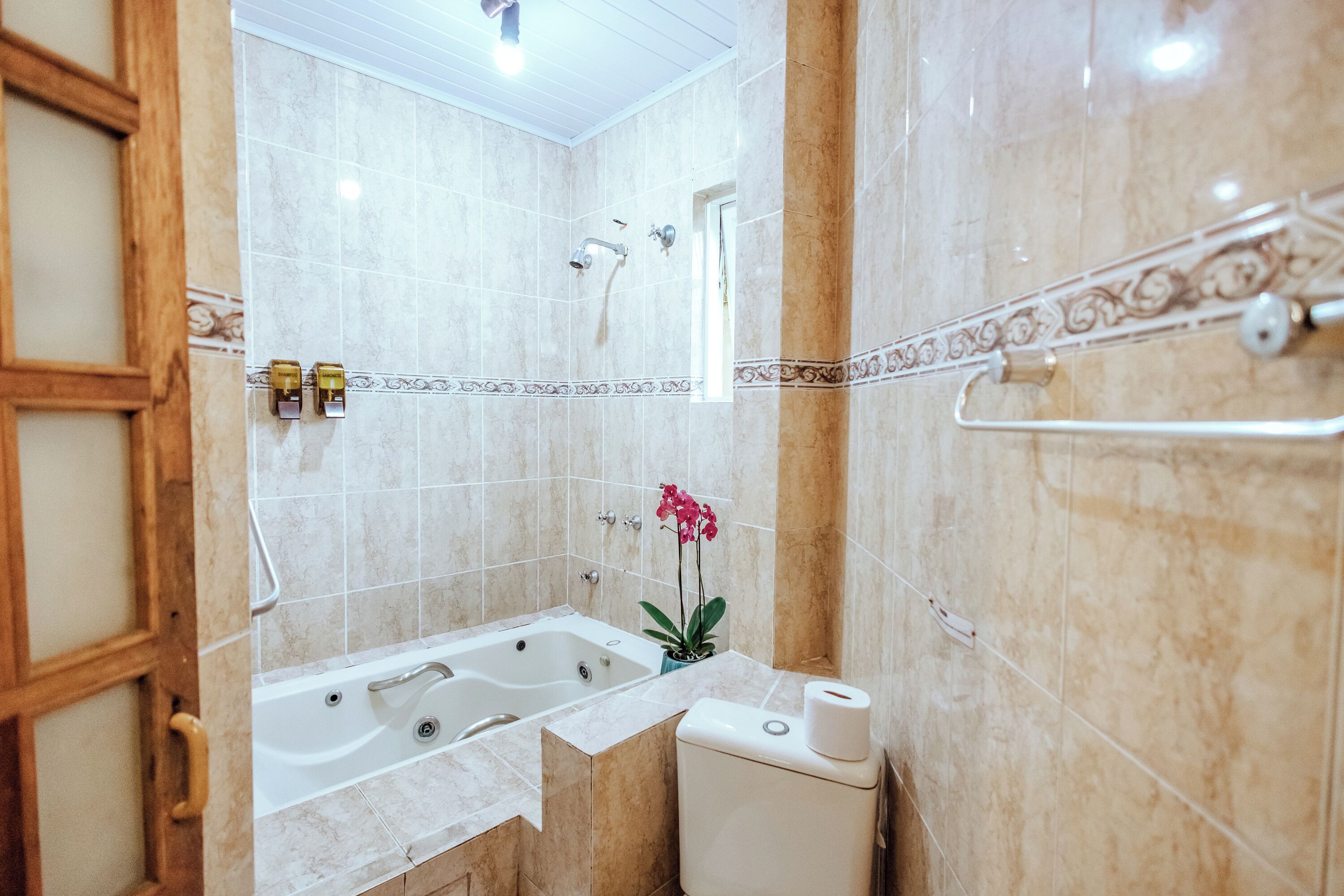 A bathroom with a bathtub, toilet, and shower.