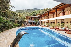 Alberca al aire libre y camastros 