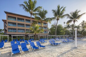 On the beach, white sand, sun loungers, beach umbrellas