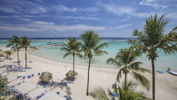 On the beach, white sand, sun-loungers, beach umbrellas