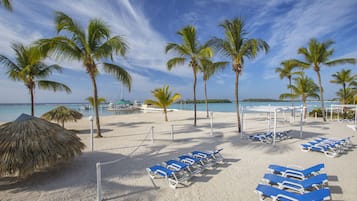 On the beach, white sand, sun-loungers, beach umbrellas