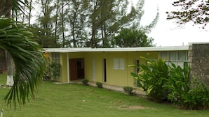 A single-story building with a flat roof, a front door, and a small porch area. - Miramar Villa (Ocho Rios)