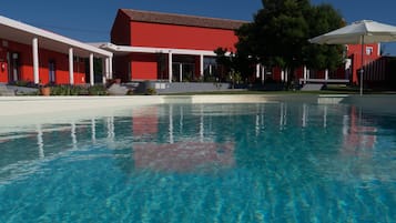 Una piscina al aire libre, tumbonas