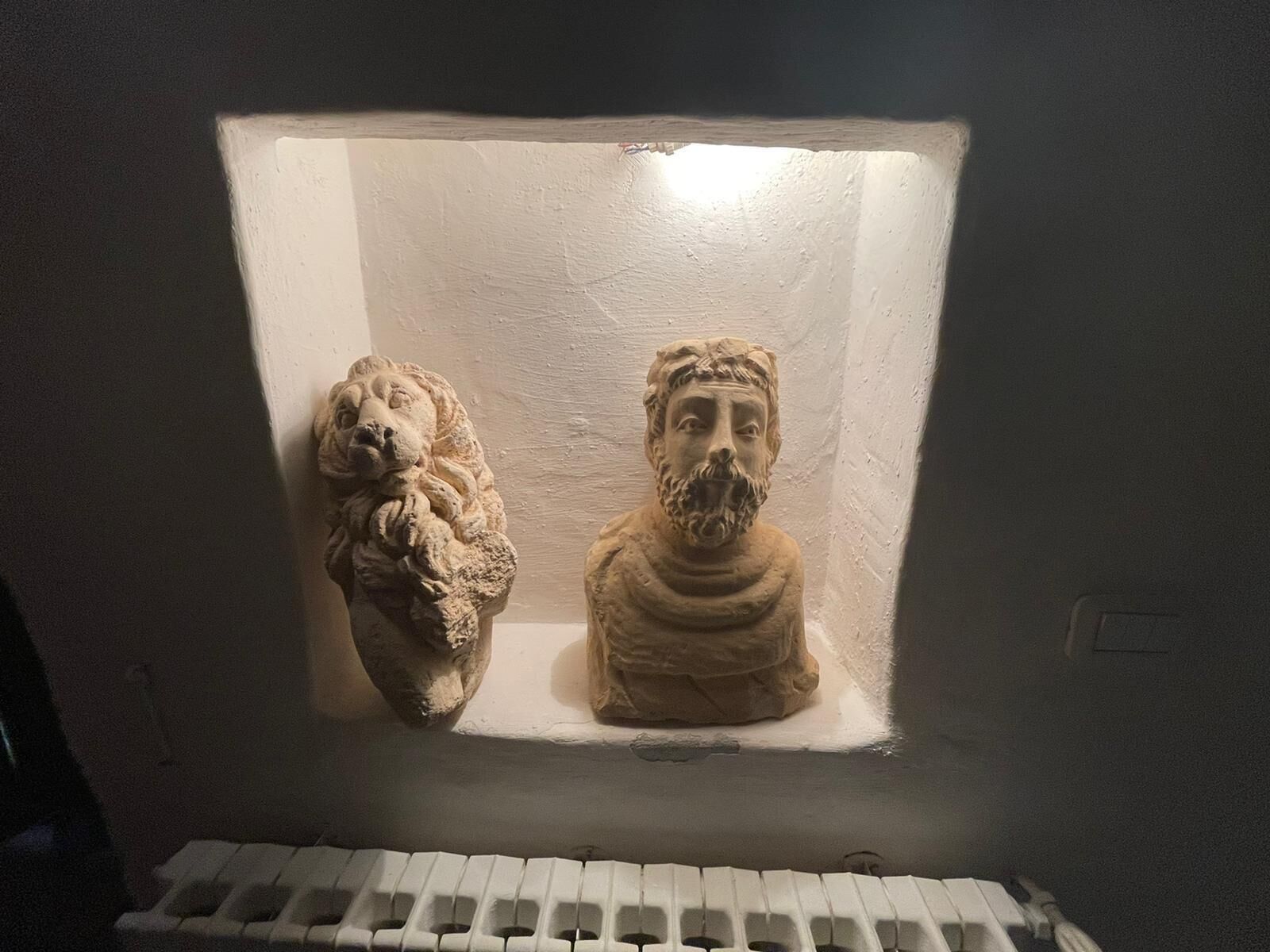 A display case with two sculptures.