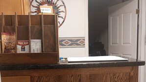 A wooden reception desk with a sign above it reading "Bed & Breakfast you make both." - Charlie's Motel (Frostburg)