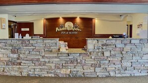 A stone reception desk with a sign for Prairie Moon Inn & Suites. - Prairie Moon Inn & Suites Unity (Unity)
